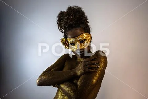 Beautiful Brazilian afro girl ready for the carnival. Golden body painting. F Stock Photos