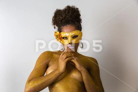 Beautiful Brazilian afro girl ready for the carnival. Golden body painting. F Stock Photos