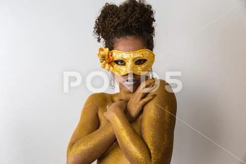 Beautiful Brazilian afro girl ready for the carnival. Golden body painting. F Stock Photos