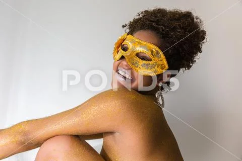 Beautiful Brazilian afro girl ready for the carnival. Golden body painting. F Stock Photos