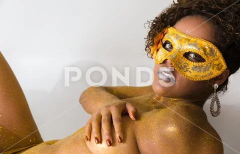 Beautiful Brazilian afro girl ready for the carnival. Golden body painting. F Stock Photos