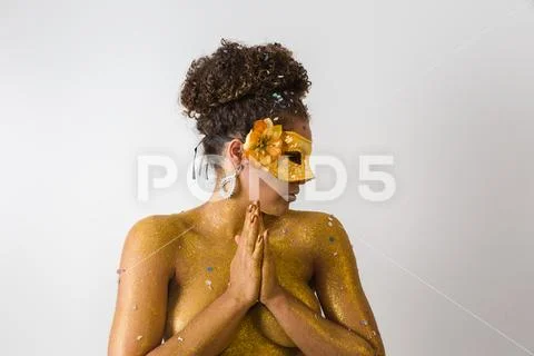 Beautiful Brazilian afro girl ready for the carnival. Golden body painting. F Stock Photos
