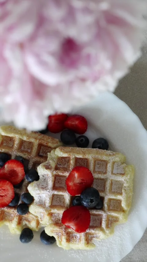 Beautiful breakfast flatlay with sweet berry waffles and bouquet of peonies Stock Footage 336902507