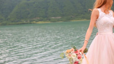 Beautiful bride against the background of a river. Wedding day Stock Footage 94742619