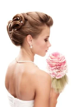 Beautiful bride with bouquet looking down at the white background Stock Photos