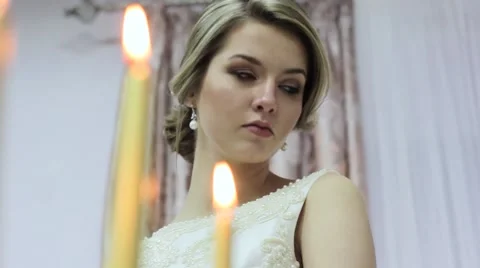 Beautiful bride with candles Stock Footage 61687704