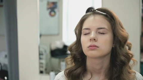 Beautiful bride gets a professional makeup Stock Footage 67820590