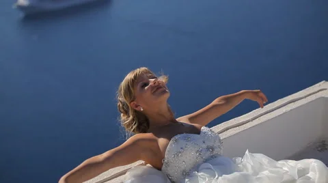 Beautiful bride having fun on the background of the Aegean Sea Stock Footage 56249548
