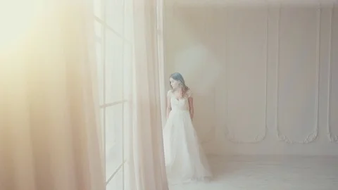 Beautiful bride looking at the big screen in a bright room in slow motion Video stock 73116592