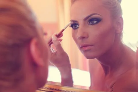 Beautiful bride looking in the mirror Stock Photos