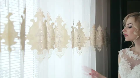 Beautiful Bride looking out a window Stock Footage 61172870