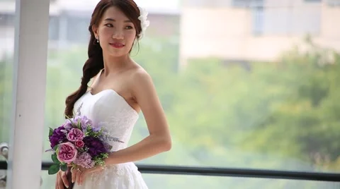 Beautiful bride in love standing in front of window and posing Stock Footage 52515331