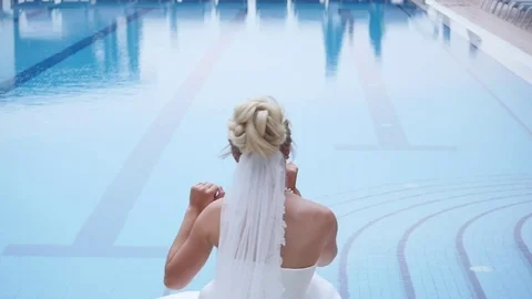 Beautiful bride near the luxury pool on the wedding day Stock Footage