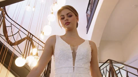 A beautiful bride poses gracefully in a stunning wedding dress Stock Footage 321623403