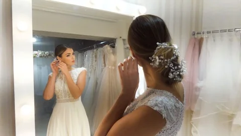 Beautiful bride poses at the mirror. Stock Footage 116779173