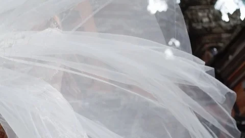 Beautiful bride posing near buddhist temple in Bali. Walking near by. Romantic Stock Footage 100733815