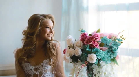 Beautiful bride posing near the window Stock Footage 67175253