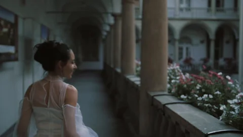 Beautiful bride runs between the columns. Italian architecture. Beautiful Stock Footage 103867216