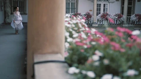 Beautiful bride runs between the columns. Italian architecture. Beautiful Stock Footage 103867240