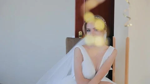 A beautiful bride is sitting and looking at the camera, smiling sincerely Stock Footage 253564213