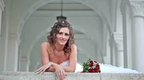 Beautiful bride smiling and greeting from a balcony Video stock 24673361