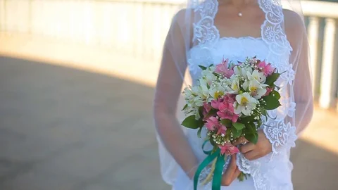 Beautiful bride standing on a balcony overlooking the sea 스톡 동영상 78984831