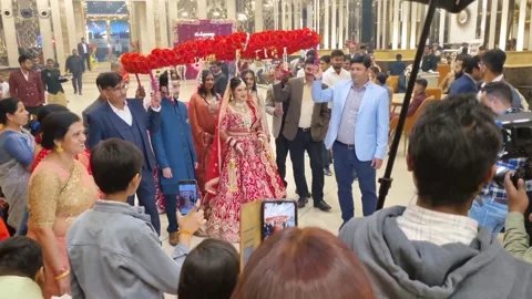 Beautiful Bride Walking to Wedding Stage with Brothers for Jaimala Ceremony Stock Footage 302828284