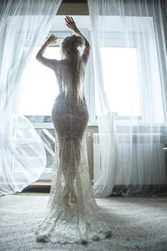 Beautiful bride by the window Stock Photos