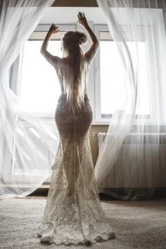 Beautiful bride by the window Stock Photos