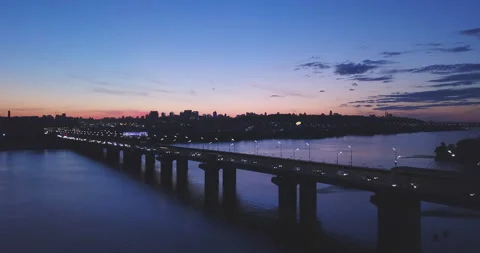Beautiful bridge against the sunset with clouds, cars go on the bridge 動画素材 150465395