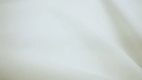 Beautiful bright cloth on the table. Close-up. Soft waves of fabric. Stock Footage 133868311
