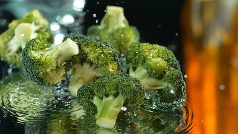 Beautiful broccoli falls on the background on the table Stock Footage 113330344