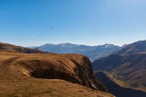 Beautiful brown mountains stand majestically against the backdrop of a sapphire Stock Photos