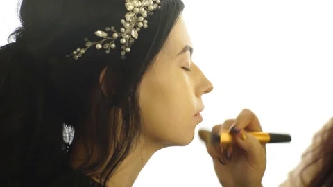 Beautiful brunette doing makeup Stock Footage 76926881