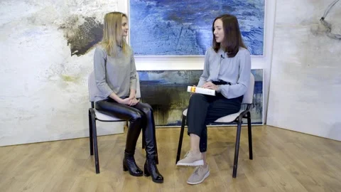 Beautiful brunette gives an interview in the studio Stock Footage 148859613