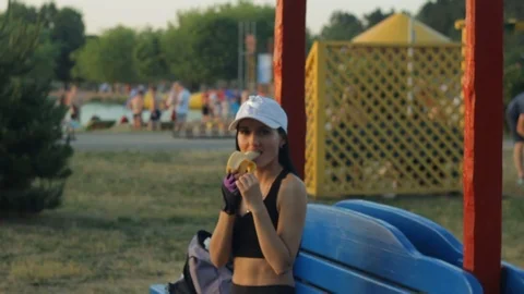 Beautiful brunette laughs and eats banana Stockbeeldmateriaal 111204490
