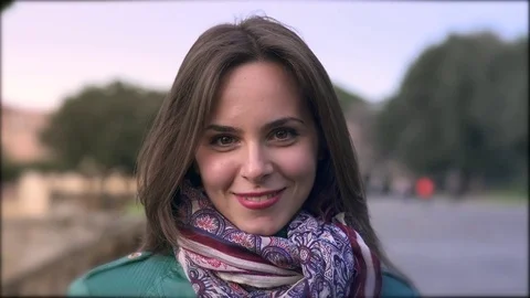 Beautiful brunette laughs looking at the camera- outdoor Stock Footage 72631095