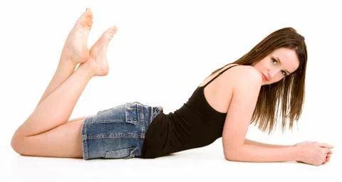 Beautiful brunette lying down isolated on white Stock Photos