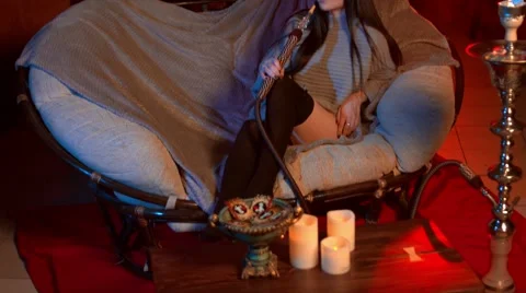 Beautiful brunette smokes a hookah in the loft room Stock Footage 68902829