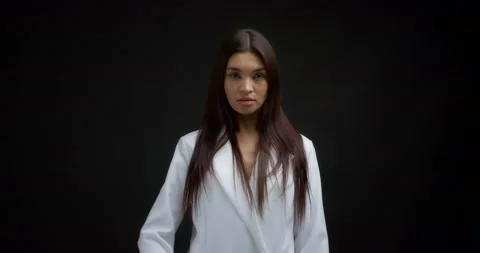 Beautiful brunette in a white jacket shows fuck you, the middle finger. Stock Footage 170196894
