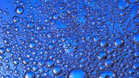 Beautiful bubbles in liquid, with a blue background. Macro shooting Stock Photos
