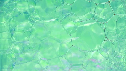 Beautiful bubbly pattern with liquid dye flowing Stock Footage 127925226