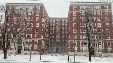 Beautiful Building in Winter with Falling Snow Stock Footage 147405506