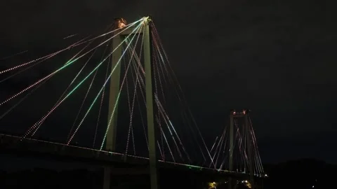 A beautiful cable-stayed bridge, glowing with lights at night. Stock Footage 227475191