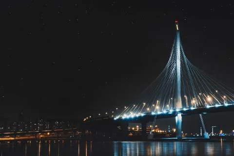Beautiful cable-stayed bridge in St. Petersburg, Russia, with starry sky and Stock Photos