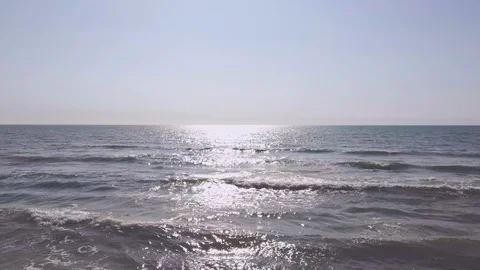 Beautiful calm sea with afternoon midday sunlight and sand beach Stock Footage