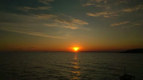 Beautiful calm sunset with only one yacht on the sea. Shooting from a drone Stock Footage 229795350