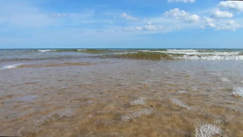 Beautiful calm waves rolling in on the sandy beach. Stock Footage 155432377