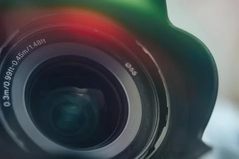 Beautiful camera lens with multi colored light of glass. Background pattern f Stock Photos