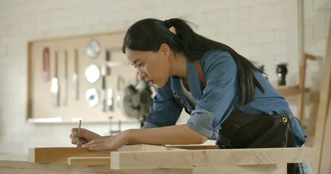 Beautiful carpenter works in carpentry workshop. Stock Footage 118116604